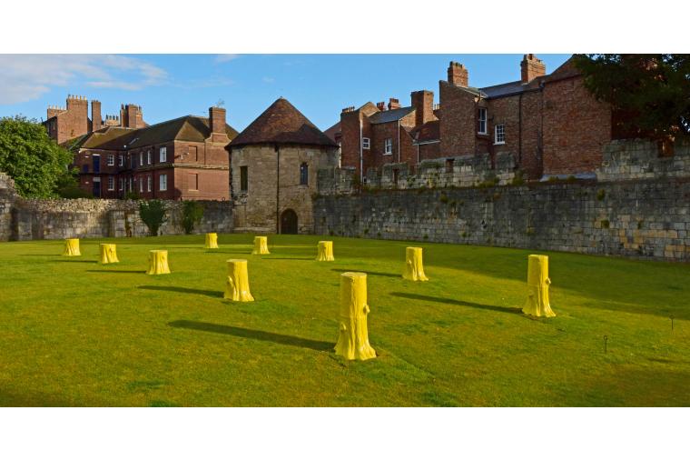 1) Foundation Myths comprises ten, life-sized, ceramic tree stumps arranged geometrically in two rows