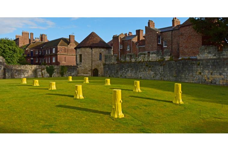 1) Foundation Myths comprises ten, life-sized, ceramic tree stumps arranged geometrically in two rows